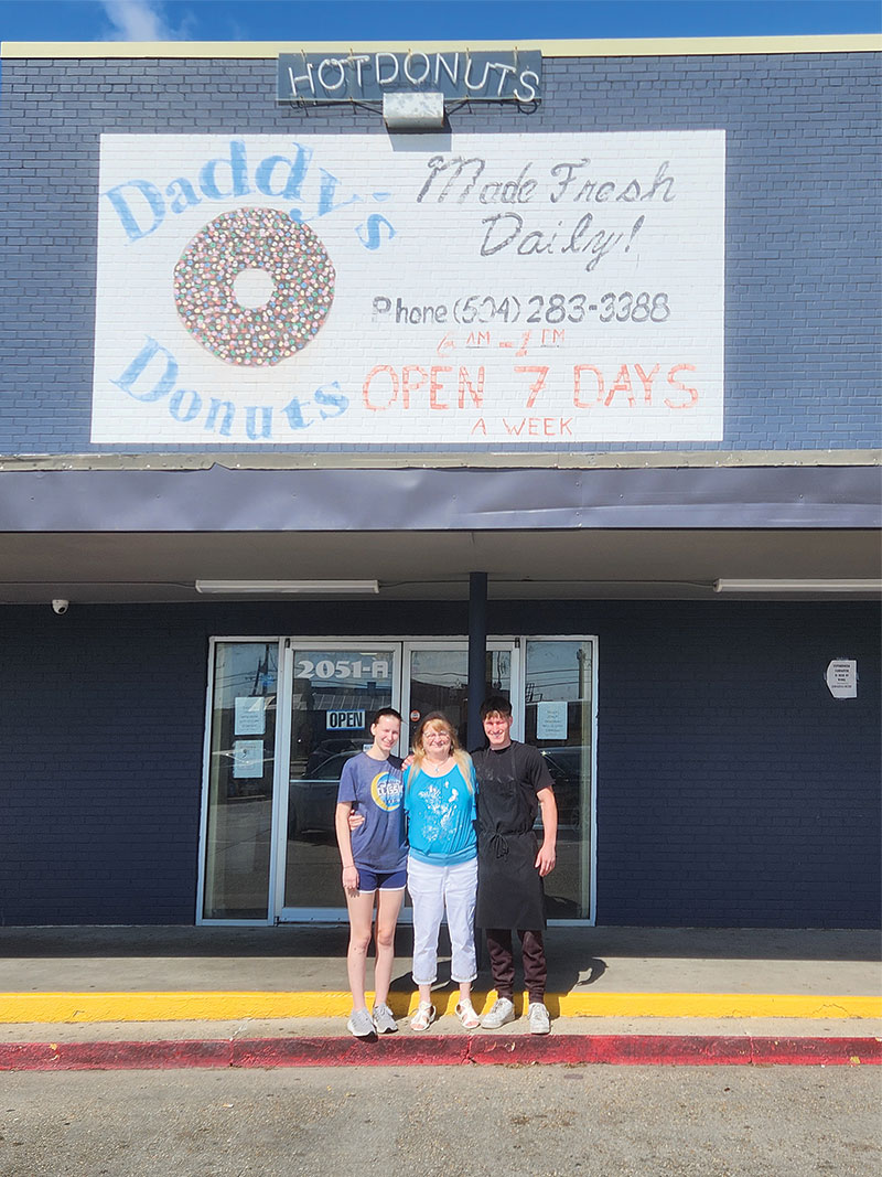 The shop’s manager under Carlton, Eileen Andrews and Carlton’s children, Chase (now 18 years old) and Brianna (16) in front of the Daddy's Donuts storefront.