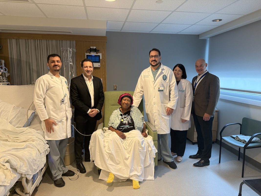 Tulane Transplant Institute at East Jefferson General Hospital team stands with first heart transplant recipient