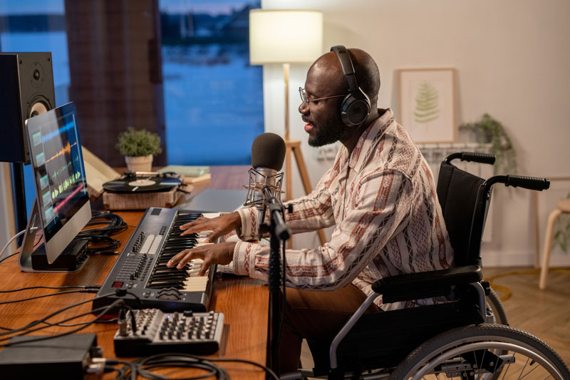 Man sitting at desk, making music.