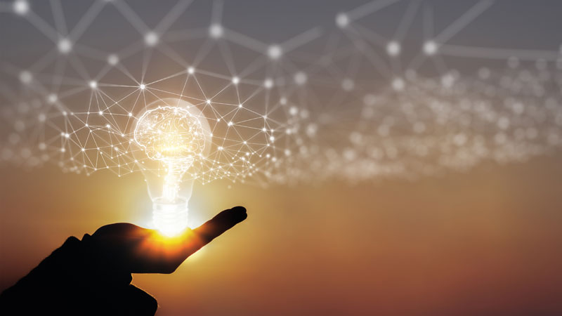 Hand holding a holographic lightbulb