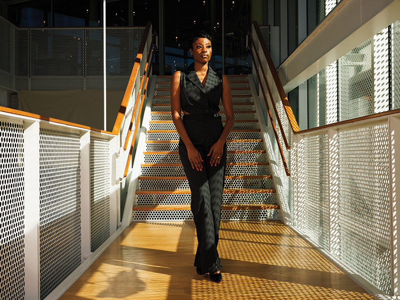 Solo shot of Claiborne standing in front of stairs
