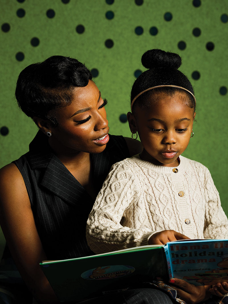 Claiborne helping her daughter read