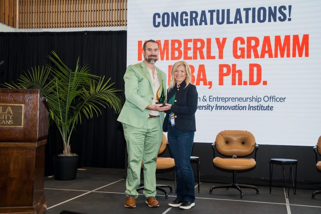 Jon Atkinson, The Idea Village, presents Kimberly Gramm, with the 1st Scott Gale Memorial Award.