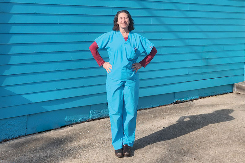 Audrey Hess, founder and owner of Mid-City Veterinary Hospital poses in front of the Vet Hospital